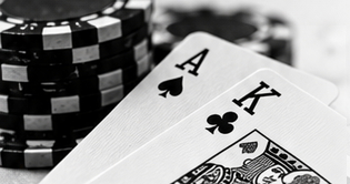 An ace of spades and king of clubs beside poker chips